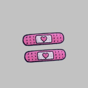 two pink bandage embroidered patches.